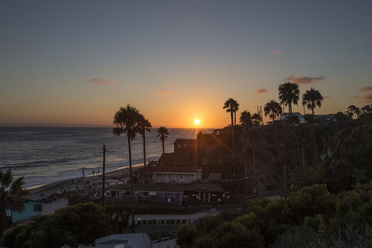 The sun sets over the Crystal Cove Beach Cottages in Newport Beach.