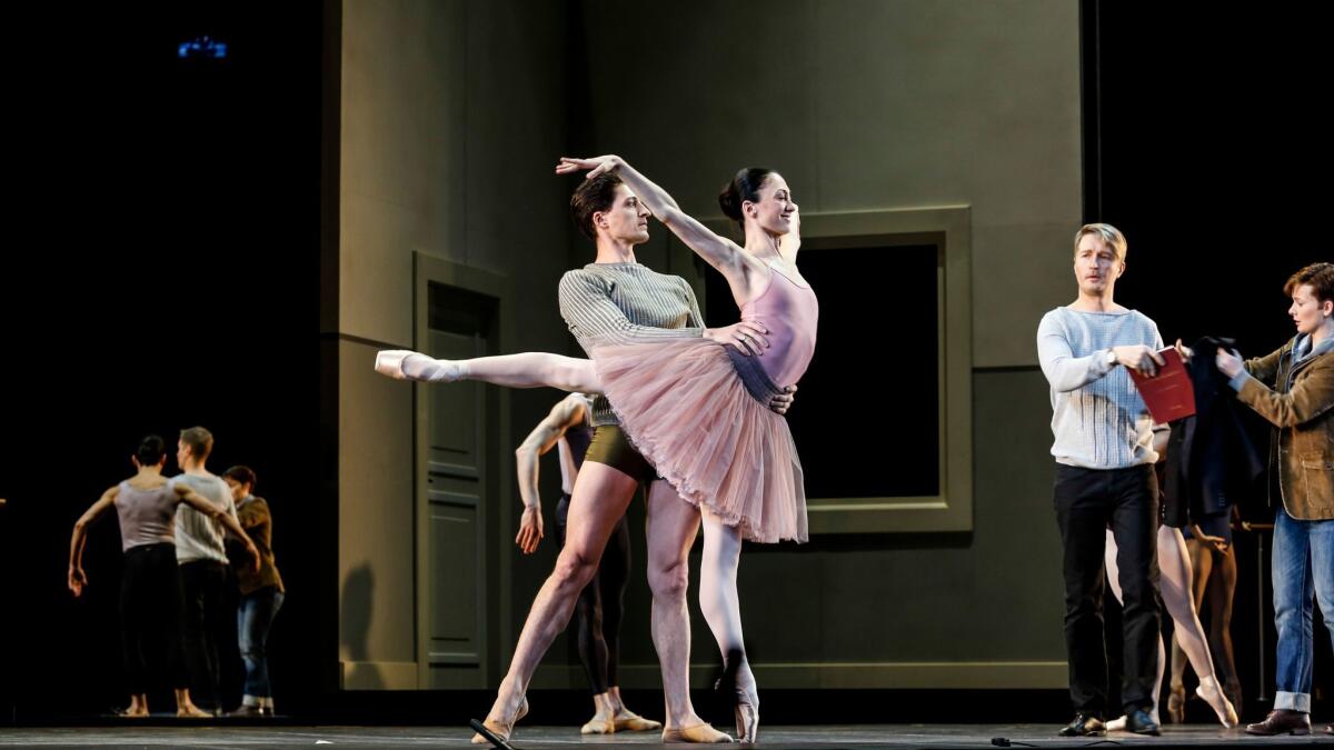 Two dancers (Temur Suluashvili and Victoria Jaiani) rehearse under the eye of choreographer Orpheus (Maxim Mironov) in John Neumeier's version of "Orpheus and Eurydice."