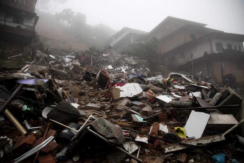 Debris from homes destroyed by a landslide caused by heavy rains in Petropolis, Rio de Janeiro state, Brazil, Saturday, March 23, 2024. (AP Photo/Bruna Prado)