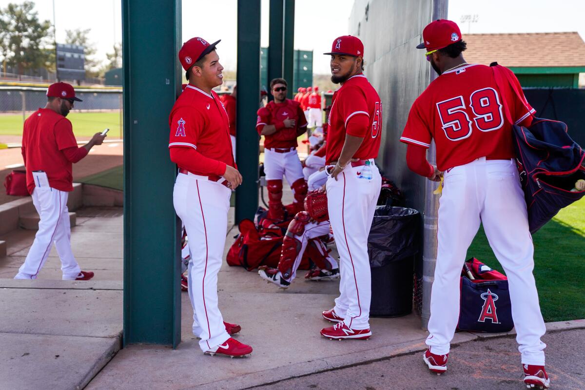 Angels pitchers (from left) Jose Suarez and Jaime Barría chat with outfielder Jo Adell at Tempe Diablo Stadium on Feb. 18.