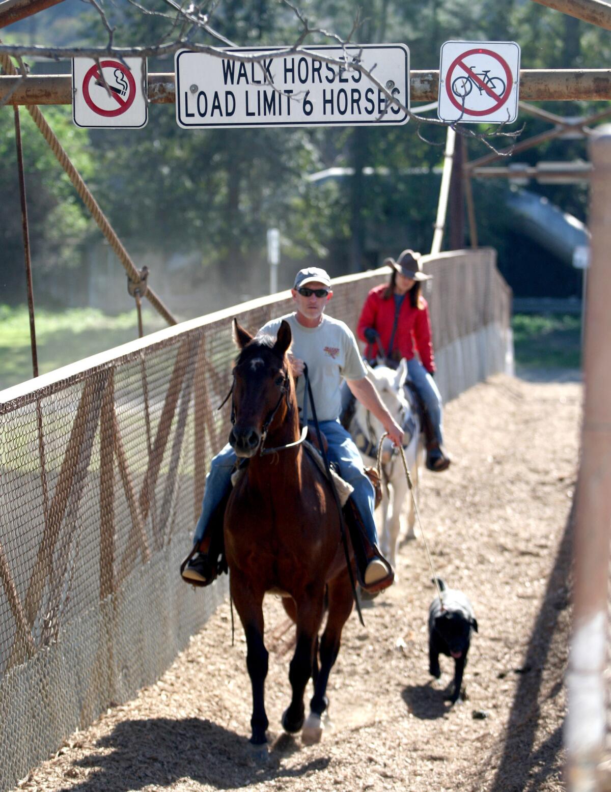 Signs stating the user rules of the Mariposa Street Bridge are clearly posted at the top of the bridge, in Burbank on Thursday, Jan. 28, 2016.