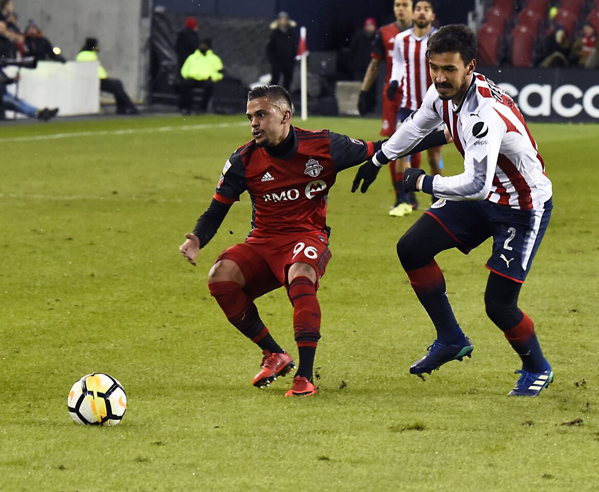 TORONTO, ON - APRIL 17: Auro Junior #96 of Toronto FC battles for the ball with Oswaldo Alans #2 of Chivas Guadalajara during the CONCACAF Champions League Final Leg 1 on April 17, 2018 at BMO Field in Toronto, Ontario, Canada. (Photo by Graig Abel/Getty Images) ** OUTS - ELSENT, FPG, CM - OUTS * NM, PH, VA if sourced by CT, LA or MoD **