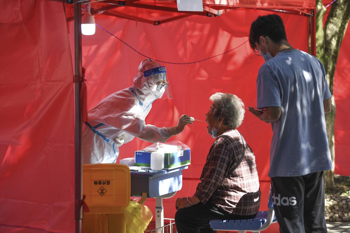 A medical worker administers a COVID-19 test in the Yunyan District of Guiyang in southwest China.