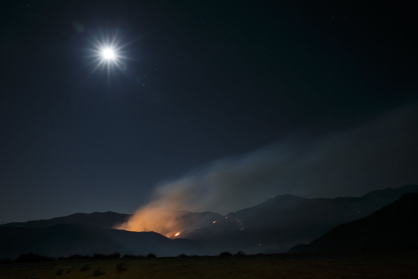 During the night, a portion of the Blue Cut fire burns along Interstate 15.