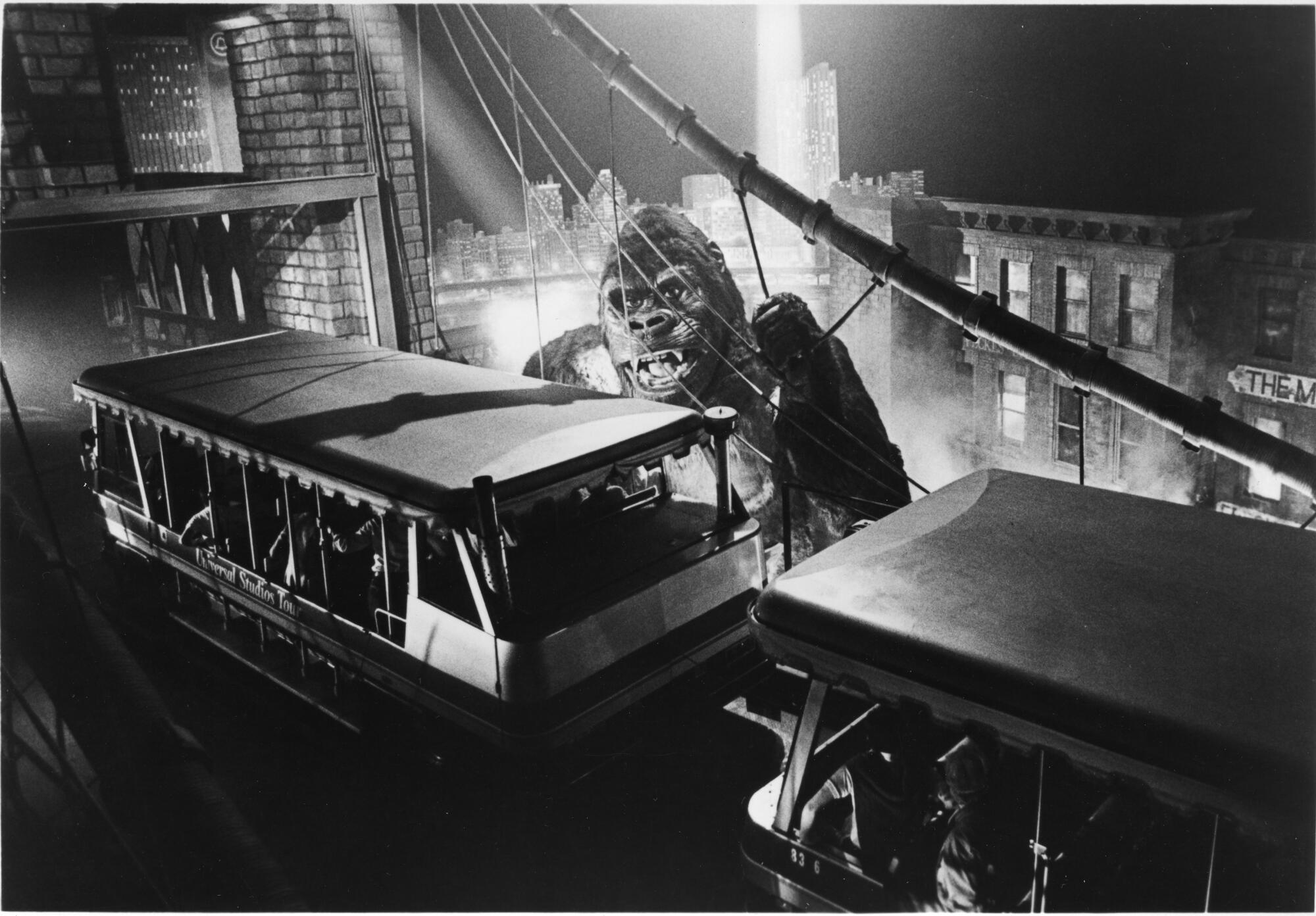 King Kong hangs on to a bridge as a tram crosses. 