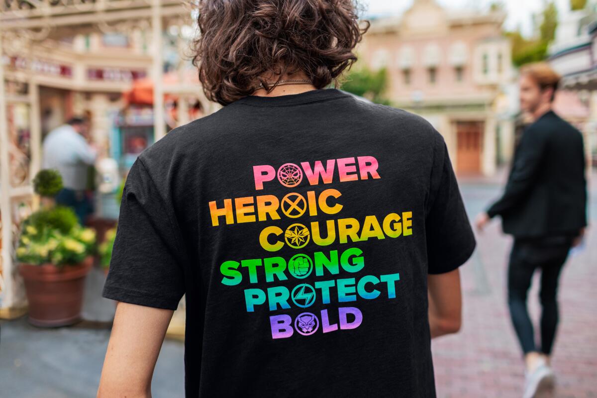A person wearing a T-shirt from Disney's "Pride Collection."