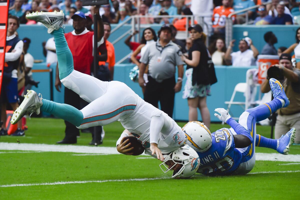 Chargers cornerback Desmond King brings down Miami Dolphins quarterback Josh Rosen during the third quarter of the Chargers' 30-10 win Sunday.