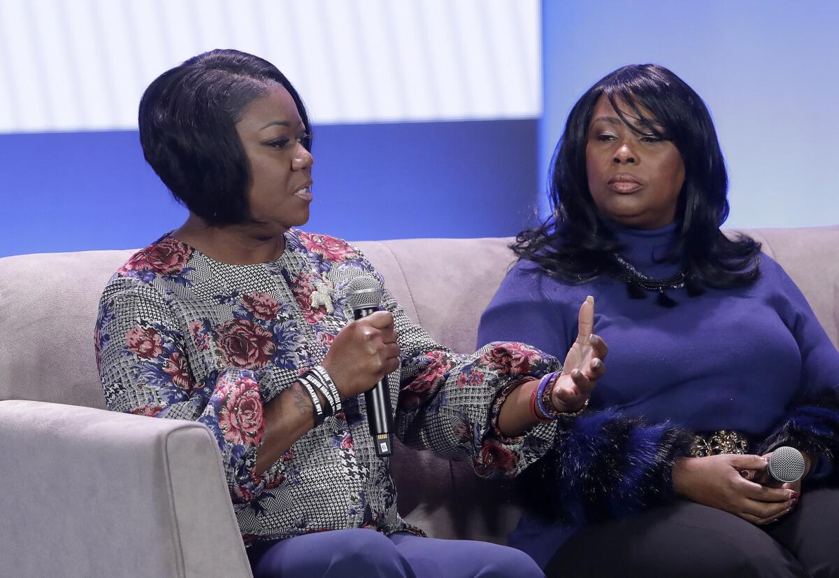 Sybrina Fulton, left, the mother of Trayvon Martin, speaks alongside Wanda Johnson, the mother of Oscar Grant, at the My Brother's Keeper Alliance symposium in Oakland on Feb. 19, 2019. Both mothers lost their sons to gun violence.