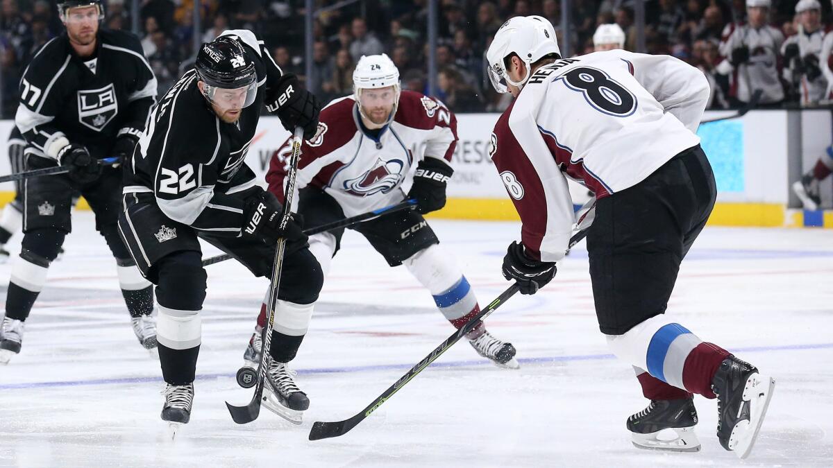 Kings forward Trevor Lewis skates with the puck in front of Colorado Avalanche defenseman Jan Hejda during the Kings' 3-1 win Saturday.