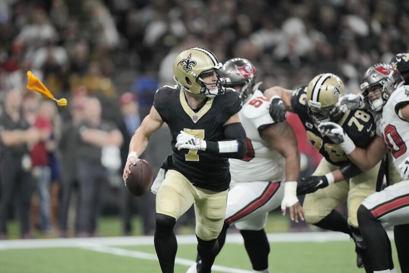 New Orleans Saints quarterback Taysom Hill (7) scrambles as a flag is thrown for offensive holding, in the first half of an NFL football game against the Tampa Bay Buccaneers, in New Orleans, Sunday, Oct. 1, 2023. (AP Photo/Gerald Herbert)