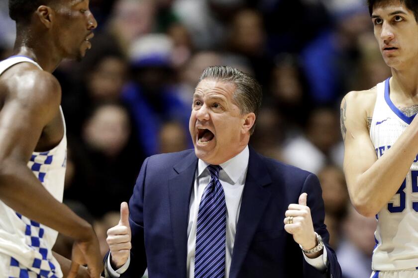 Kentucky Coach John Calipari talks strategy with Edrice Adebayo, left, and Derek Willis during the first half of their SEC tournament game against Alabama on March 11.