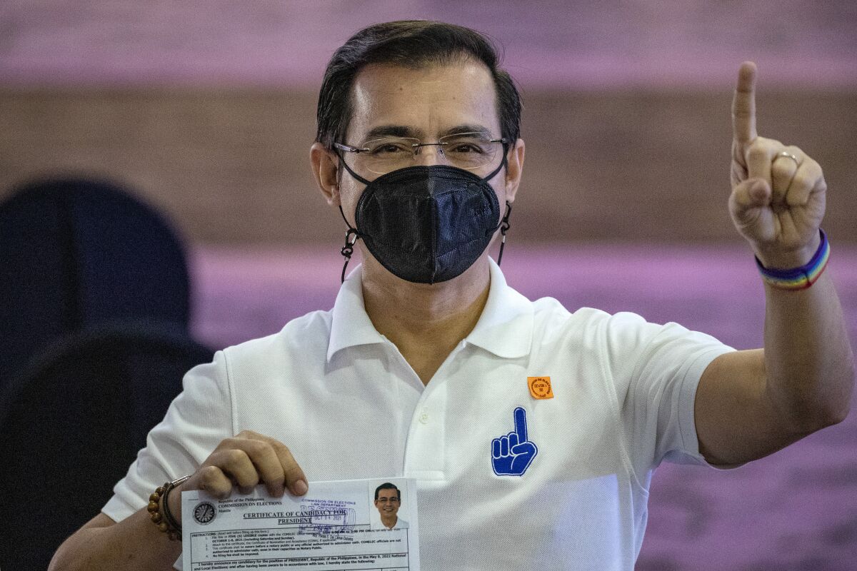 Manila City Mayor Isko Moreno gestures after filing his certificate of candidacy for next year's presidential elections before the Commission on Elections at the Sofitel Harbor Garden Tent in Metropolitan Manila, Philippines on Monday Oct. 4, 2021. Politicians continue to register as candidates seeking to lead the Southeast Asian nation that has been hit hard by the pandemic and deep political conflicts. (Ezra Acayan/Pool Photo via AP)