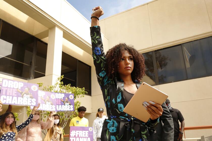 SAN LUIS OBISPO, CA - AUGUST 25: 20-year-old activist Tianna Arata addresses a rally Tuesday on the steps of the San Luis Obispo County Courthouse as supporters rally to protest her arrest following an anti-racism protest that allegedly ended in car vandalism on July 21, 2020 in San Luis Obispo that has sparked a national outcry. Arata was arrested on multiple felony accounts, but was subsequently released later that evening. The district attorney's office is currently reviewing Arata's case to determine what her charges will be. Her arraignment is set for Sept. 3. Today's rally was hosted by the Free Tianna Coalition, which is backed by BLM co-founder Patrisse Cullors. Courthouse on Tuesday, Aug. 25, 2020 in San Luis Obispo, CA. (Al Seib / Los Angeles Times