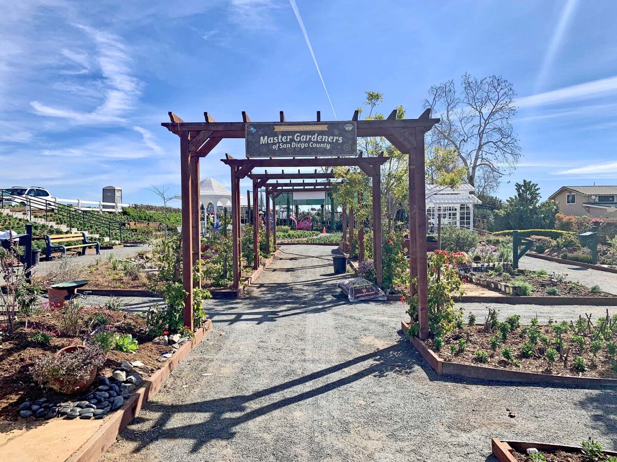 A series of arbors welcomes visitors to tour a demonstration garden with multiple zones.