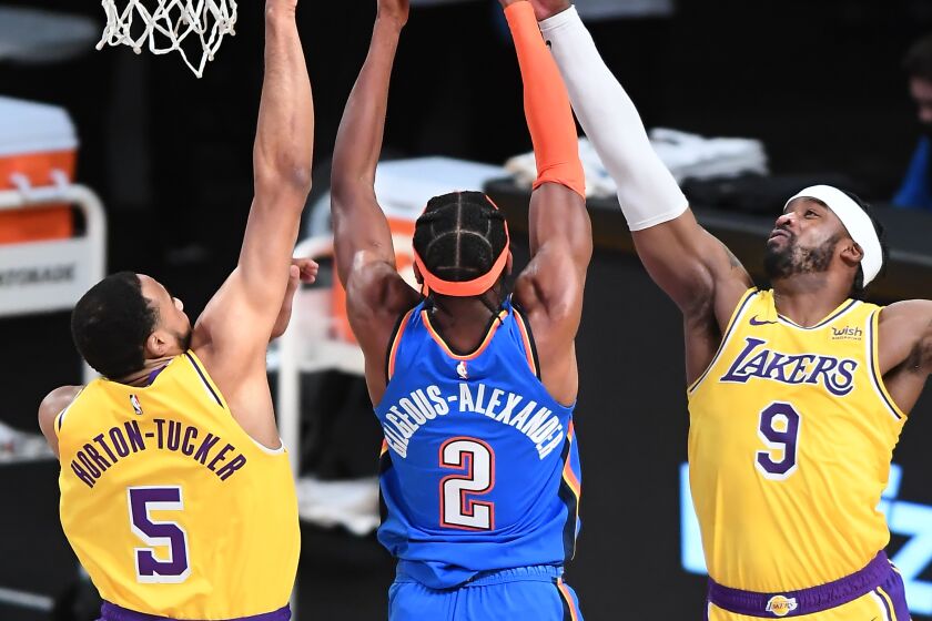 LOS ANGELES, CALIFORNIA FEBRUARY 8, 2021-Lakers Wesley Matthews (9) blocks the shot of Thunders Shai Gilgeous-Alexander as Talen Horton-Tucker helps on defense in the first quarter at the Staples Center Monday. (Wally Skalij/Los Angeles Times)