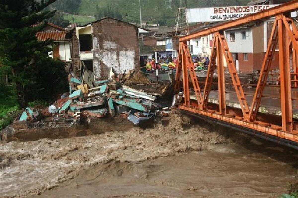 View of a destroyed bridge near Inca's Sacred Valley town of Pisac in Cuzco, Peru on Monday, Jan. 25, 2010. Heavy rains and mudslides in Peru blocked the train route to the ancient Inca citadel of Machu Picchu, keeping nearly 2,000 tourists stranded.(AP Photo/Roxabel Ramón/El Comercio)