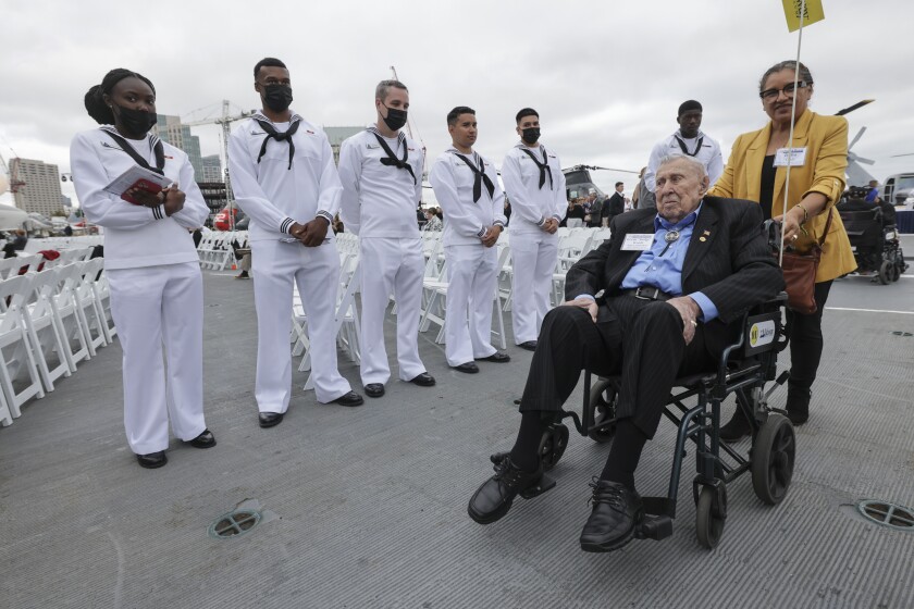 Navy sailors stand in line as Battle of Midway veteran Ervin 