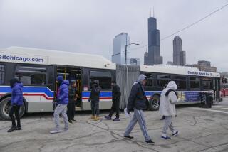 Chicago Transit Authority "warming" buses for migrants are parked in the 800 block of South Desplaines Street Thursday, Jan. 11, 2024, in Chicago. In the city of Chicago's latest attempt to provide shelter to incoming migrants, several buses were parked in the area to house people in cold winter weather. (AP Photo/Erin Hooley)