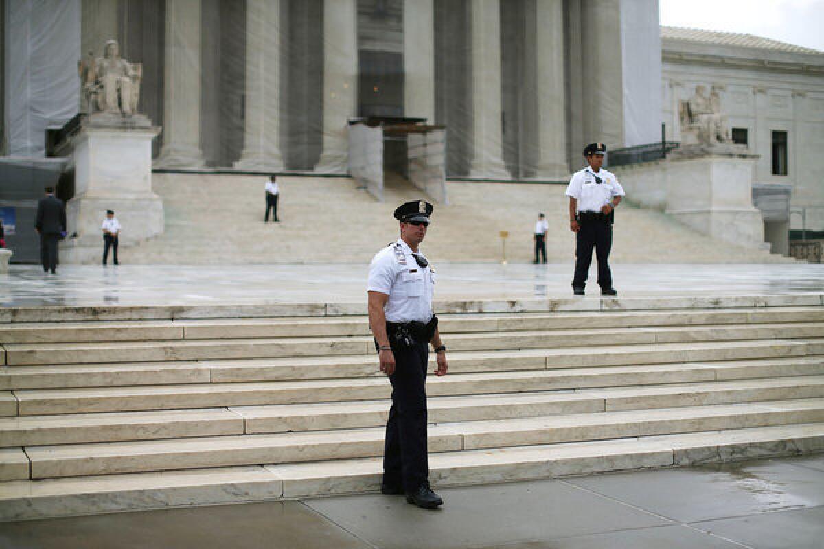 Police stand guard in front of the U.S. Supreme Court building on Monday.