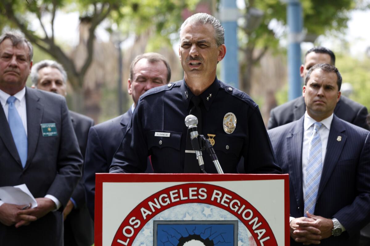 LAPD Deputy Chief Kirk Albanese and other authorities hold a press conference at Jesse A. Brewer Jr. Park to announce the results of "Operation Broken Heart," which resulted in the arrest of more than 275 "child predators," according to a press release.
