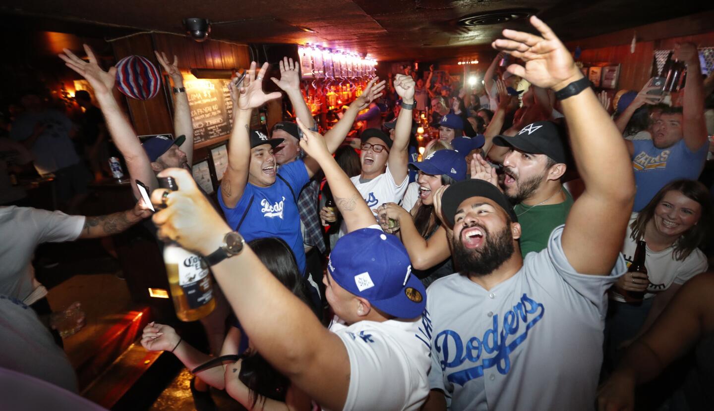 Dodger fans cheer as the Dodgers beat the Houston Astros 3-1 in Game 1 of the World Series at The Short Stop bar and grill near Dodger Stadium.