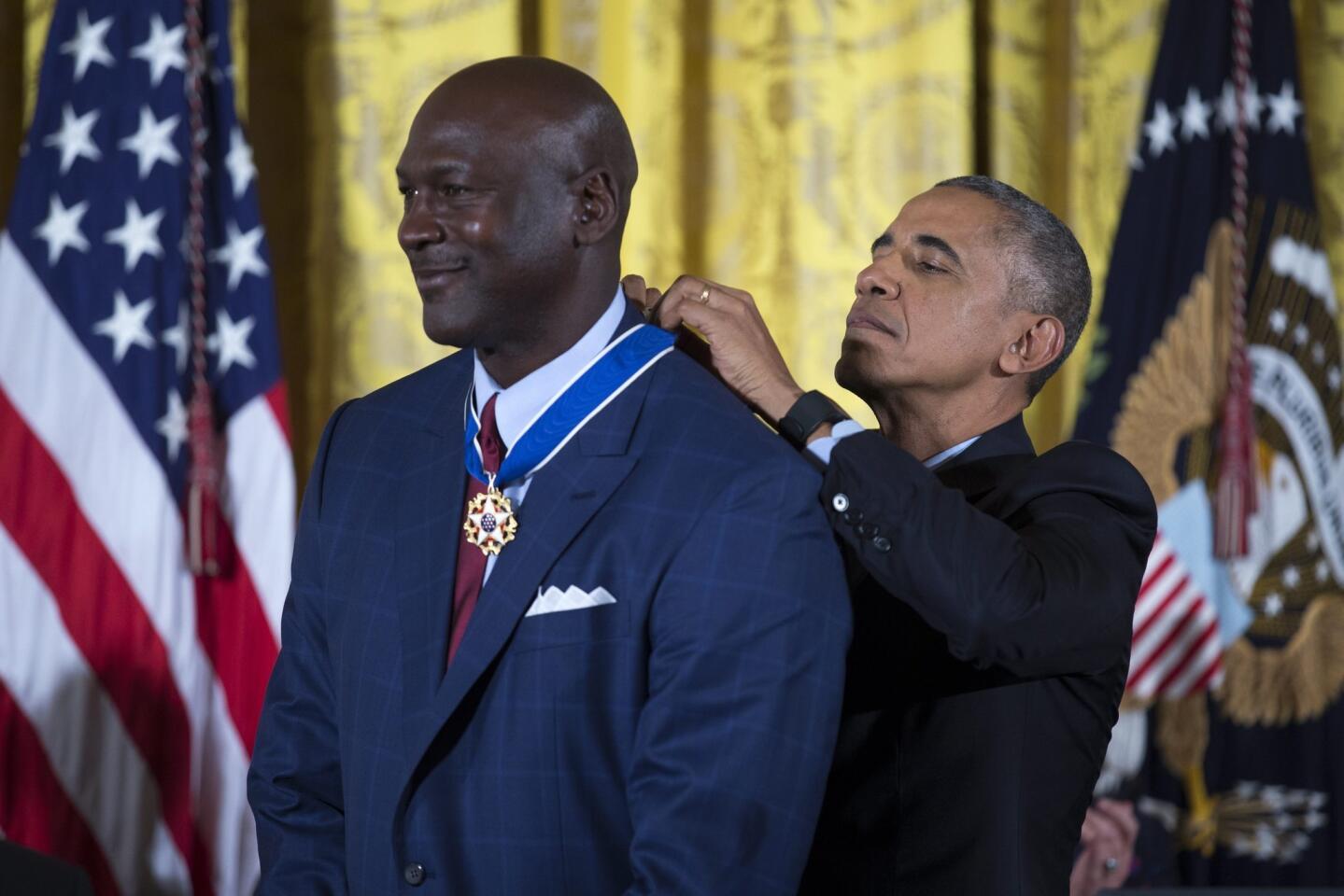 NBA legend Michael Jordan receives his medal.
