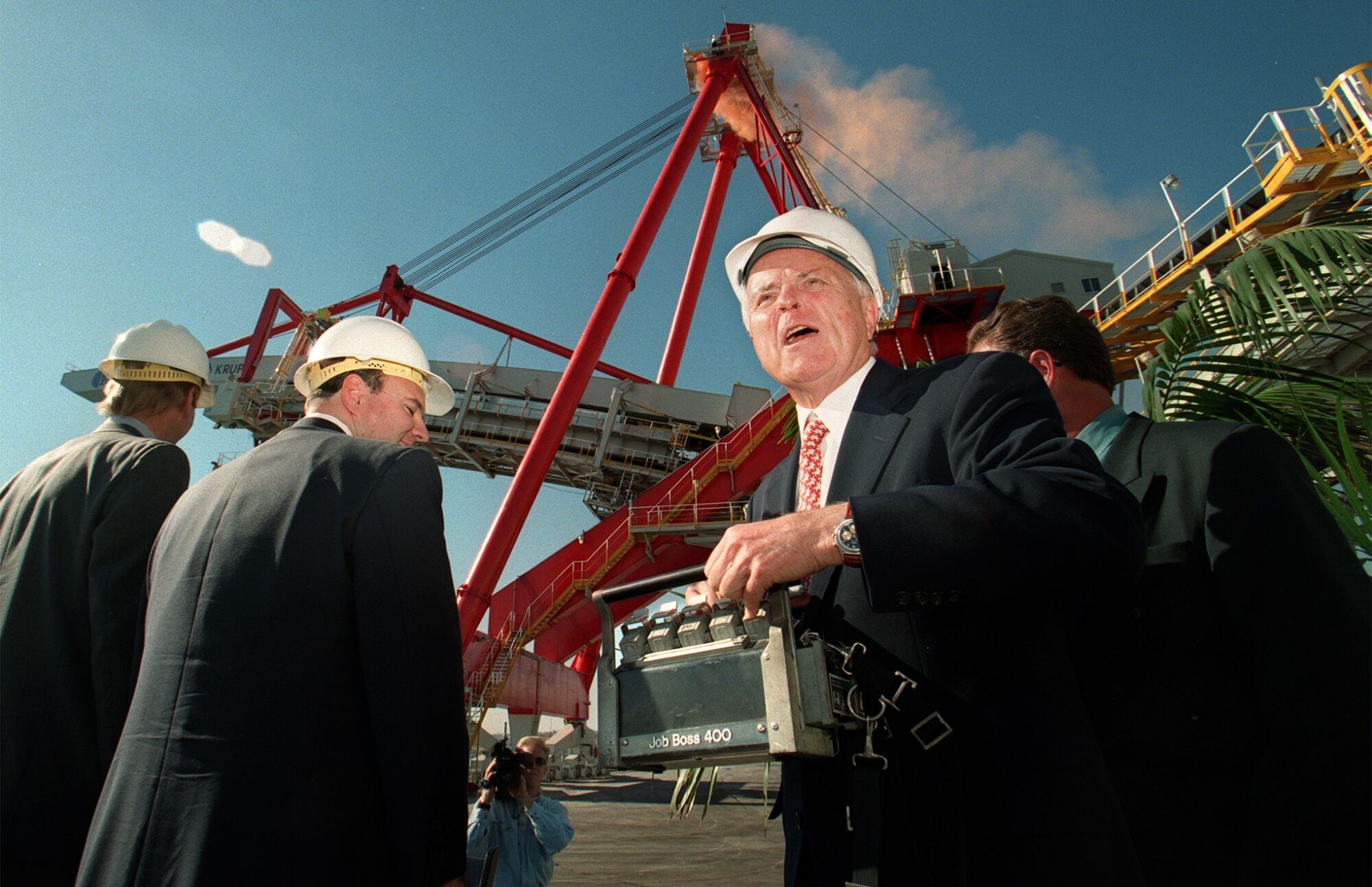 Los Angeles Mayor Richard Riordan steers a loading crane during a ceremony at the port.
