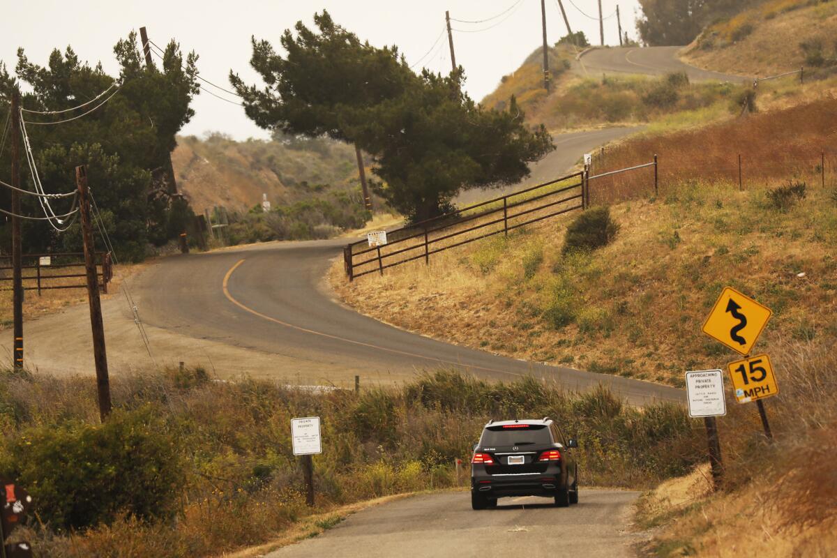 Vehicles navigate the narrow curving Hollister Ranch Road. (Al Seib / Los Angeles Times)