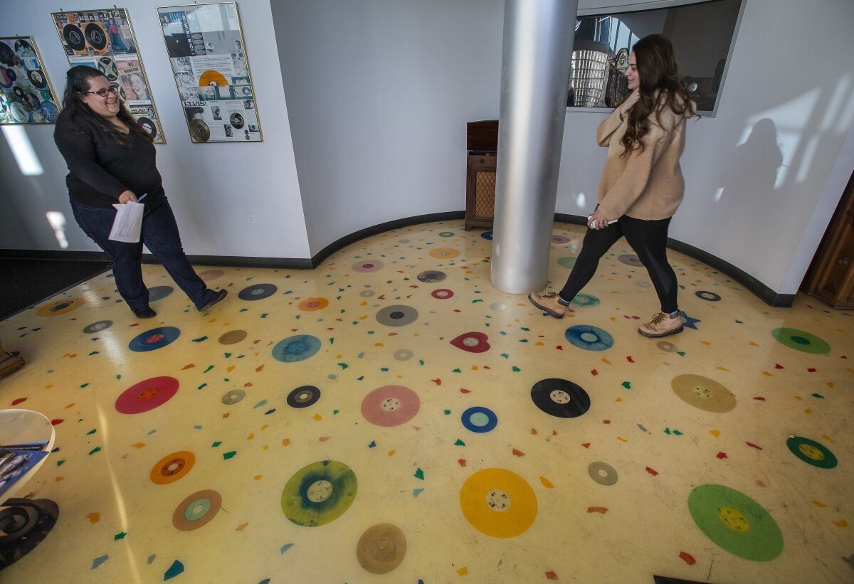 Diana Morales, left, and Gina Spaccia in Rainbo's record-themed lobby floor.