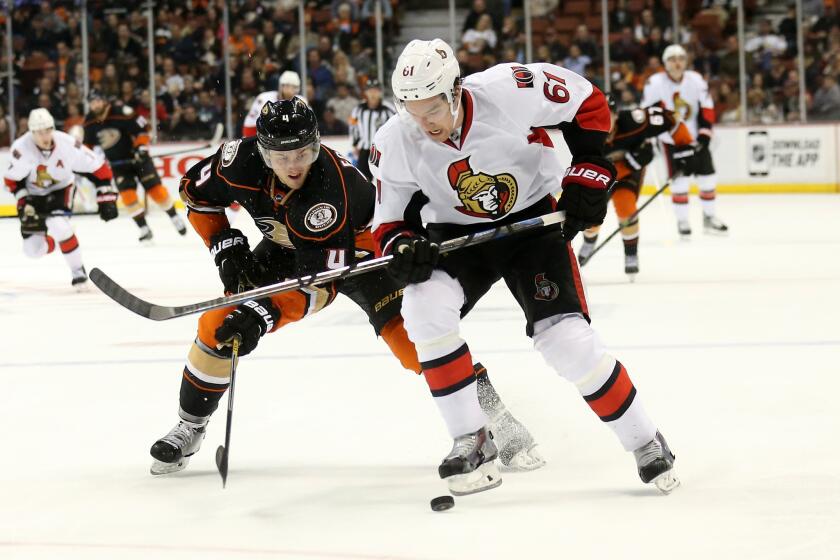 Cam Fowler battles with Ottawa's Mark Stone during the Ducks' 3-0 loss to the Senators on Wednesday at Honda Center.