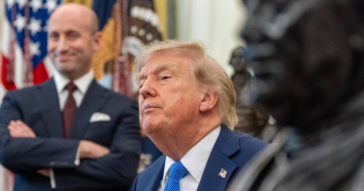 Photo: Los Angeles Times President Donald Trump speaks as White House deputy chief of staff for policy Stephen Miller listens, in the Oval Office of
