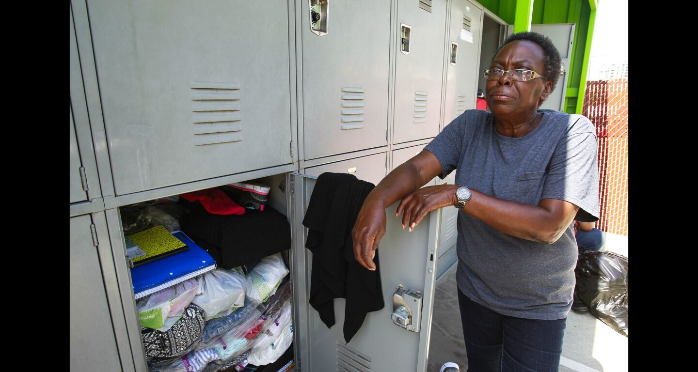 Beverly Tanner, a San Diego City College student that is homeless, stands next to a storage locker she can use at a locker facility for homeless people, operated by Think Dignity, in San Diego.