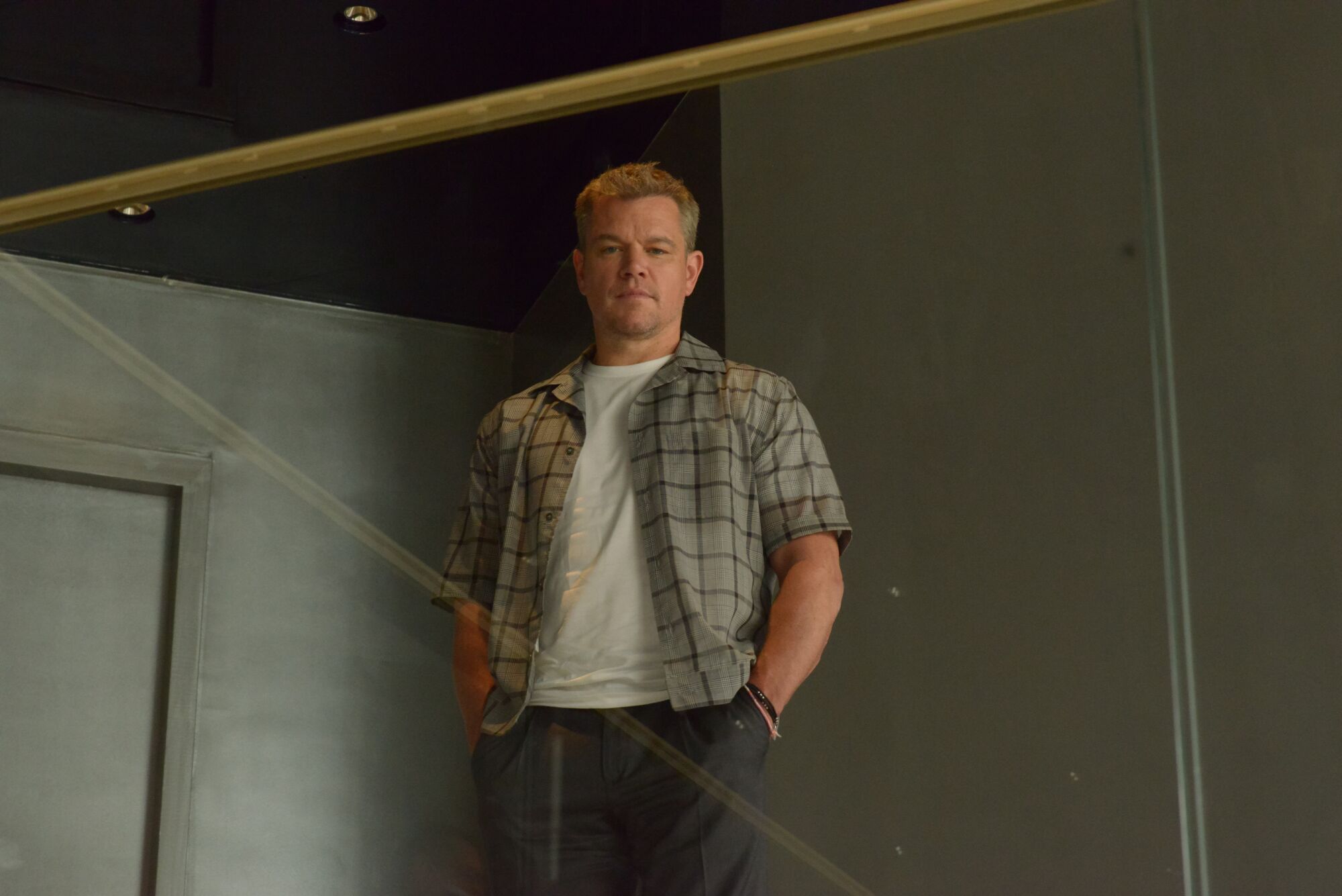 Matt Damon stands with his hands in his pockets.