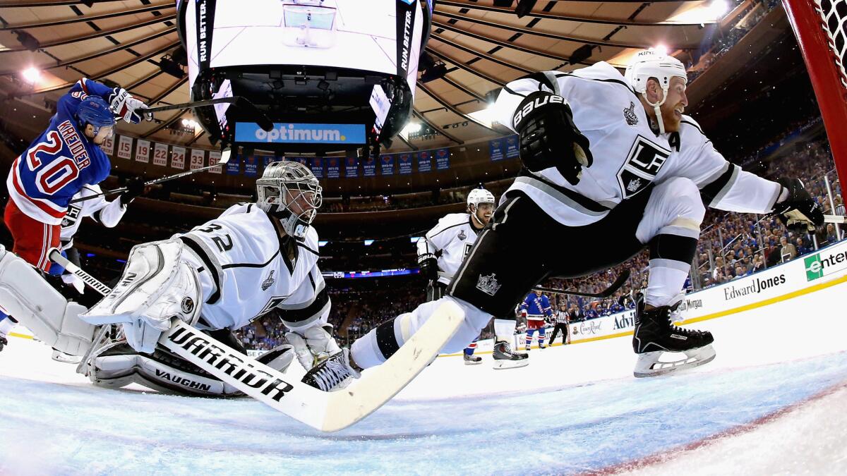 Kings goalie Jonathan Quick and defenseman Matt Greene, right, try to block a shot by New York Rangers forward Chris Kreider during the second period of the Kings' 3-0 win Monday in Game 3 of the Stanley Cup Final. Greene played a big role in keeping New York scoreless on the power play.