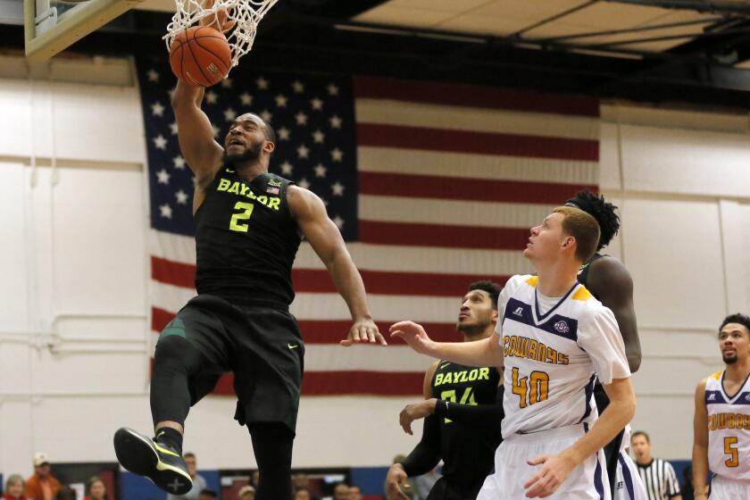 Baylor forward Rico Gathers (2) dunks as Hardin-Simmons' Justin Jones (40) watches during the second half a game held in Fort Hood, Texas. Baylor won 104-59.