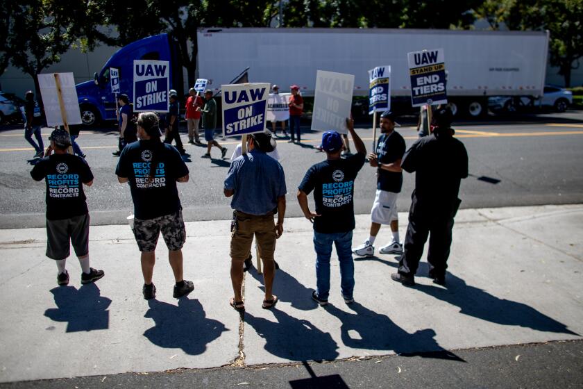 ONTARIO, CA - SEPTEMBER 26, 2023: Striking United Auto Workers (UAW) march in front of the Stellantis Mopar facility on September 26, 2023 in Ontario, California. They are striking to get a 36% wage increase, to end tiered pay and to convert temp workers to full-time.(Gina Ferazzi / Los Angeles Times)