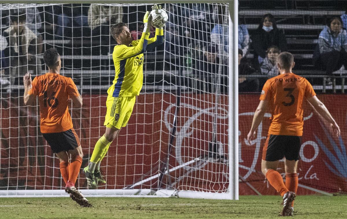 Orange County Soccer Club goalkeeper Patrick Rakovsky blocks a shot during a game against the San Diego Loyal.