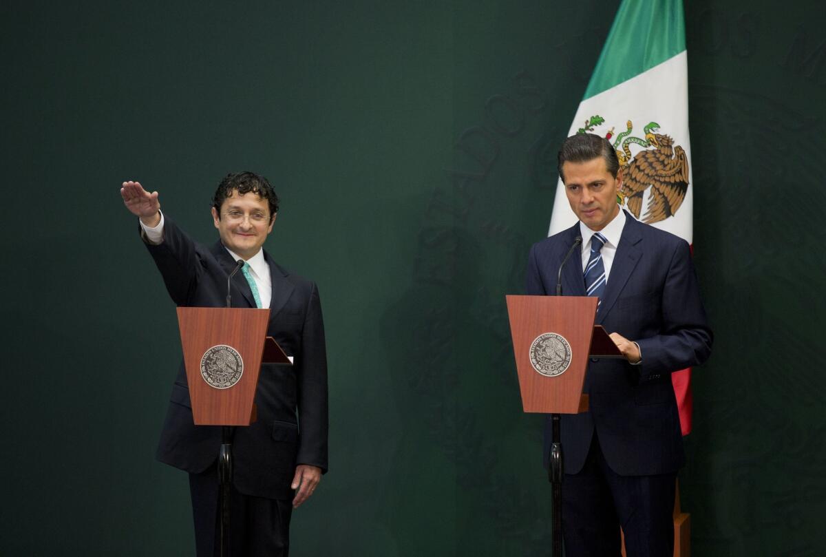 Virgilio Andrade, left, is sworn in as secretary of public function by Mexican President Enrique Peña Nieto on Tuesday in Mexico City.