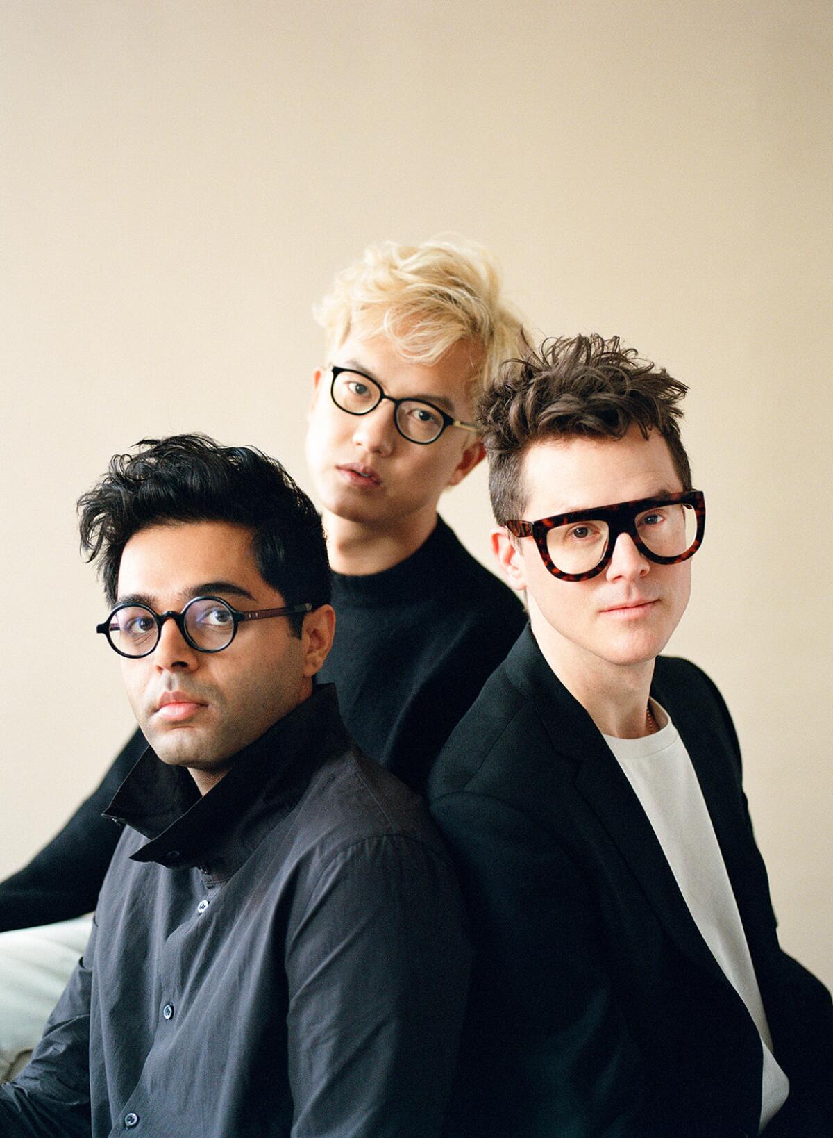 The three members of Son Lux pose for a group photo.