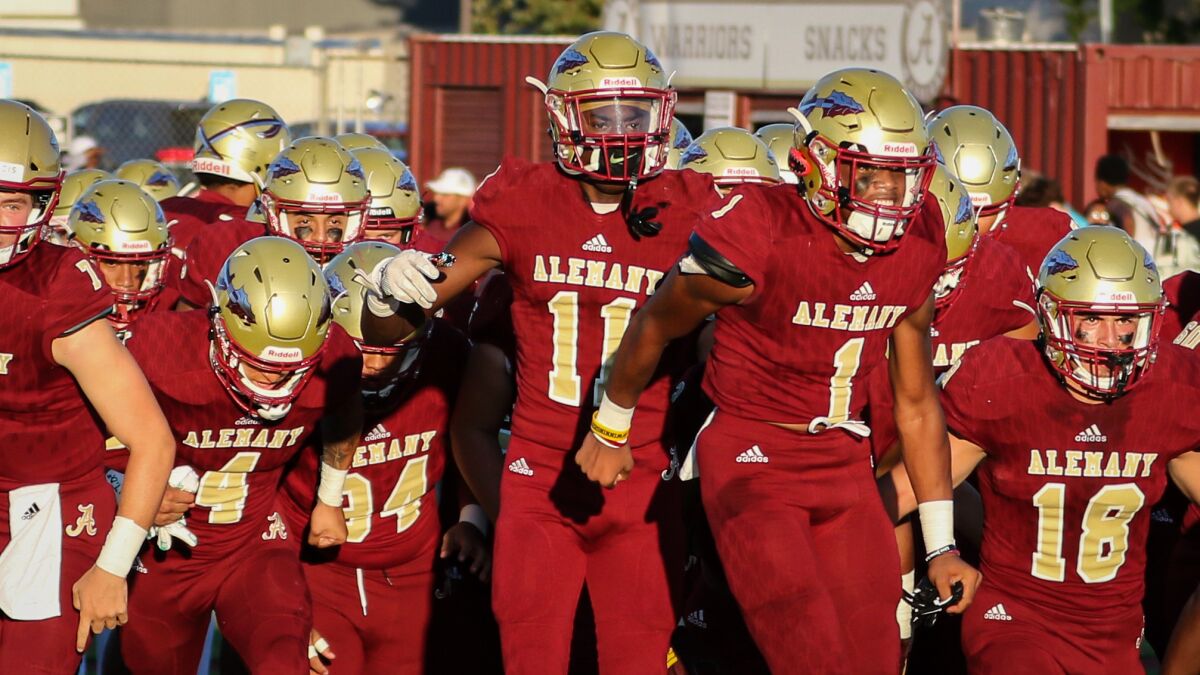 Senior Jalin Speed (11) runs onto the field with his Bishop Alemany teammates before a game against Jordan High from Sandy, Utah, on Aug. 16.