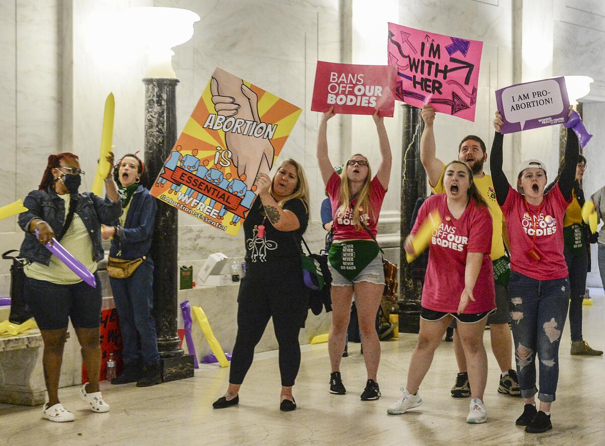 Abortion rights supporters demonstrate outside the Senate chamber at the West Virginia state Capitol  in Charleston, W.Va.