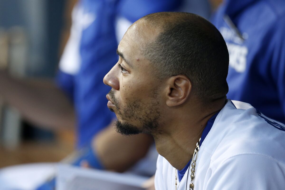 Dodgers right fielder Mookie Betts watches from the dugout against the Phillies on Friday.