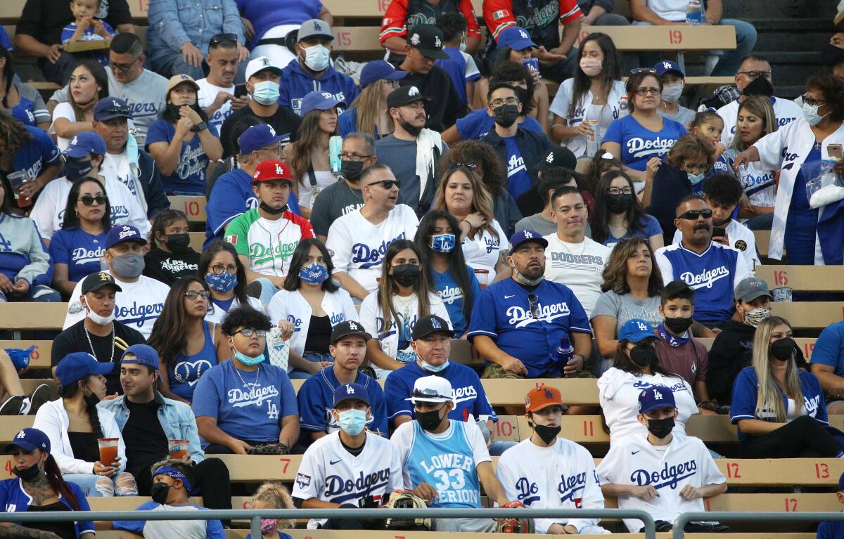 Fans sit in the bleachers at Dodger Stadium.