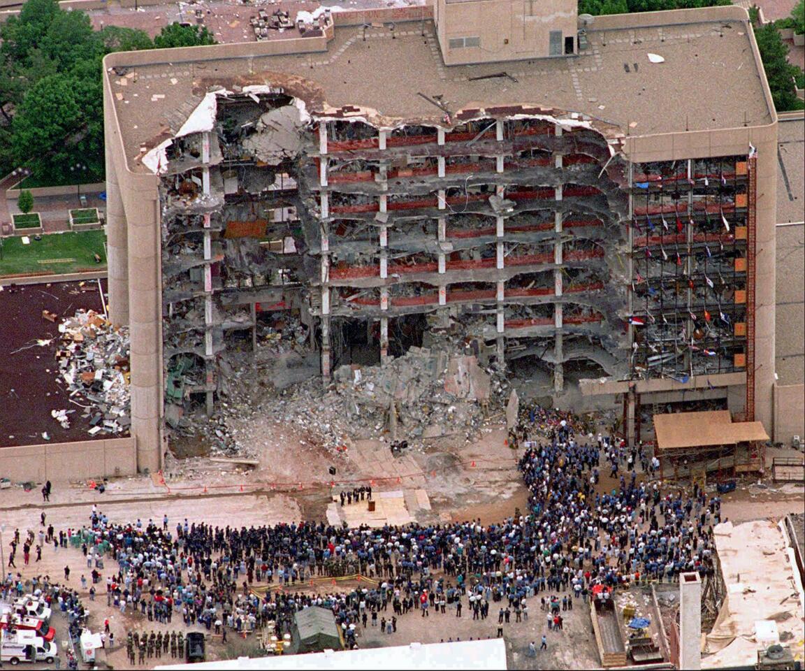 In this May 5, 1995 file photo, a group of search and rescue workers attends a memorial service in front of the bombedAlfred P. Murrah Federal Building in Oklahoma City.