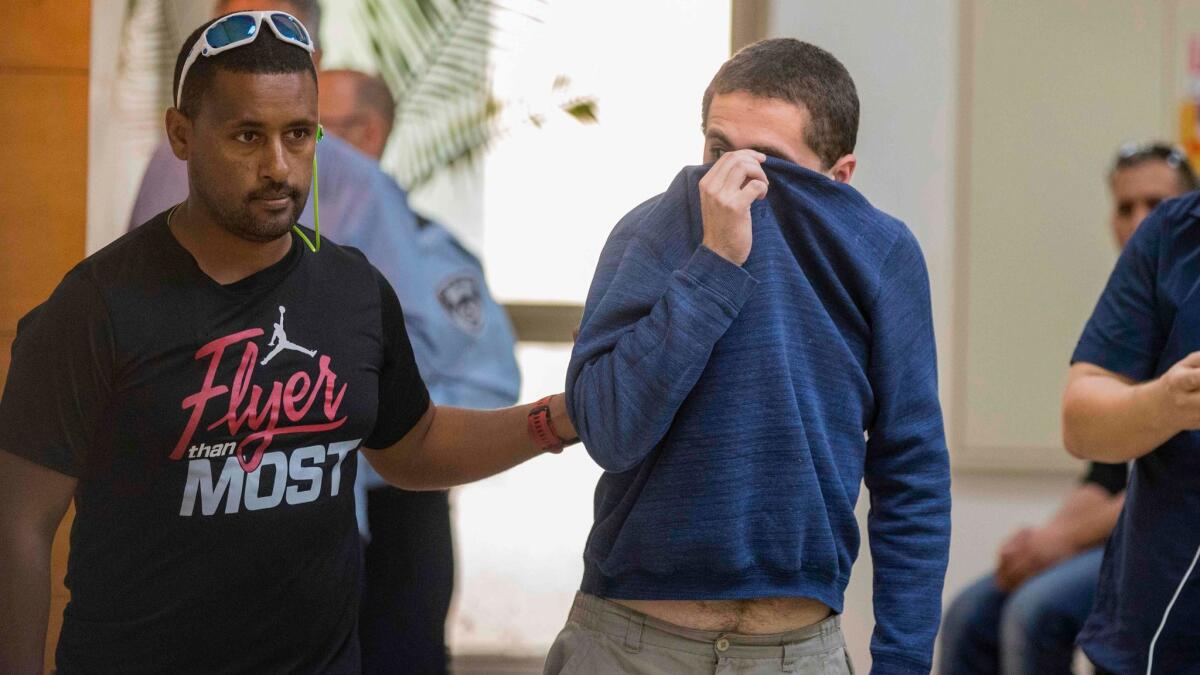 An Israeli teen, right, was arrested last year on charges of making dozens of hoax bomb threats against U.S. Jewish institutions.