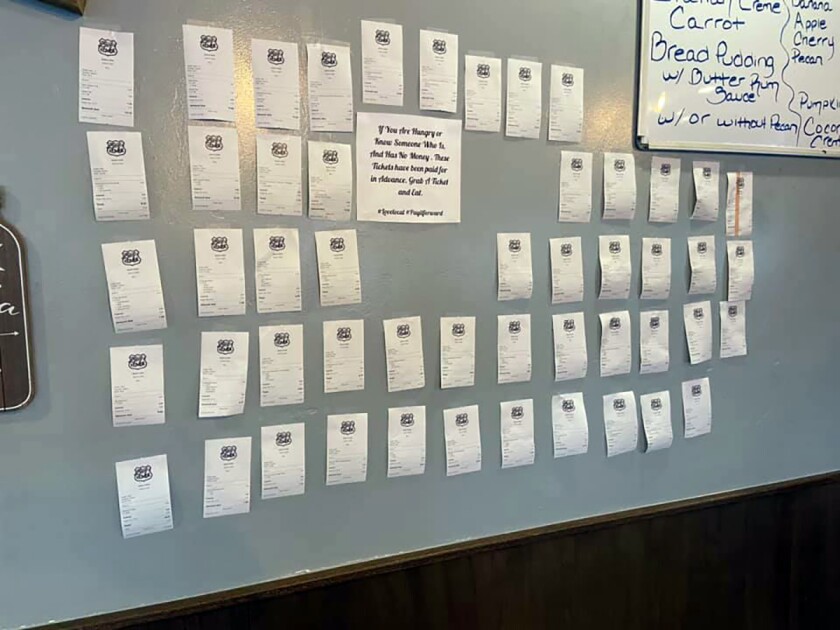 In this Feb. 5, 2021, photo provided by Zack's Cafe, receipts for pre-paid meals hang on the wall inside Zack's Cafe in Miami, Okla. Customers pay for them so that people in need, many of them struggling financially due to the coronavirus pandemic, can get a meal, judgment-free and no questions asked. (Zack's Cafe via AP)