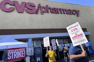 Workers on strike picket in front of a CVS pharmacy on Saturday, Oct. 19, 2024, in Los Angeles. (AP Photo/Jaimie Ding)