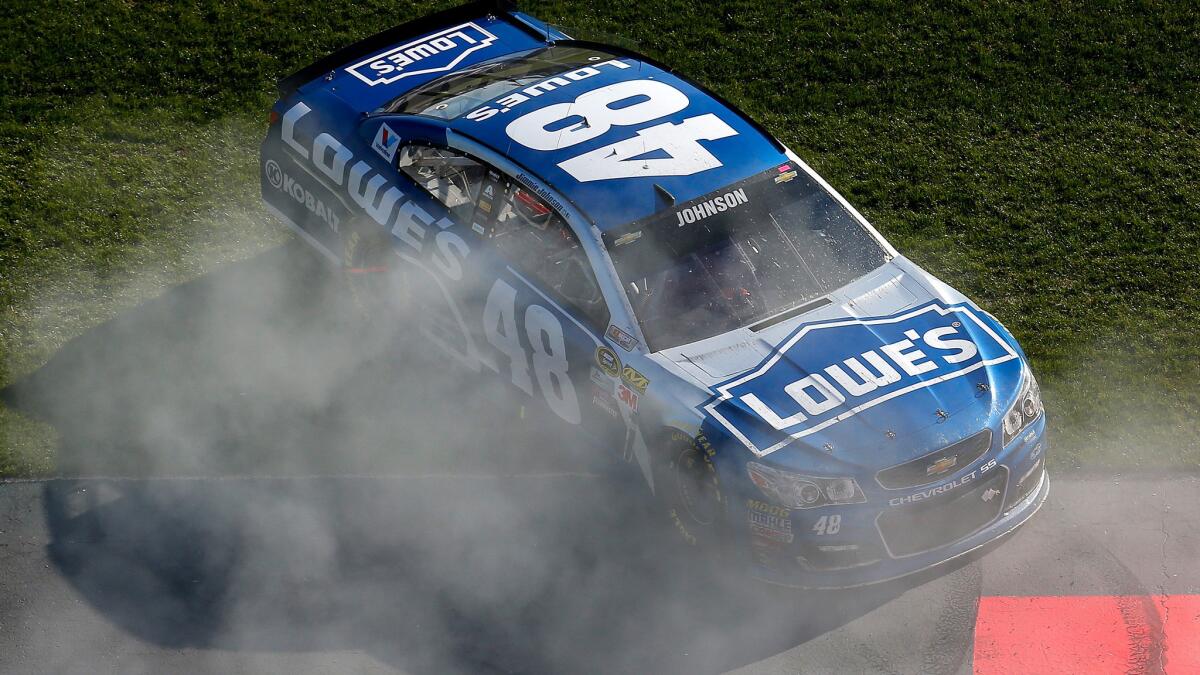 NASCAR driver Jimmie Johnson celebrates with a burnout after winning the NASCAR Sprint Cup Series Folds of Honor QuikTrip 500 at Atlanta Motor Speedway on Sunday.