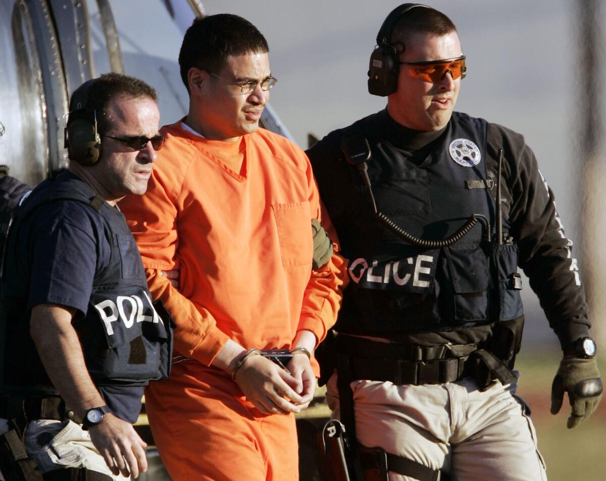 @@*@@* FILE @@*@@* In this Jan. 5, 2006, file photo, Jose Padilla, center, is escorted by federal marshalls on his arrival in Miami. It's been nearly five years since then-Attorney General John Ashcroft declared the United States had thwarted an al-Qaida plot to detonate a radioactive "dirty bomb" in a major city and had arrested a "known terrorist," Jose Padilla. However, as jury selection begins Monday, April 16, 2007 the case against Padilla has no mention of the "dirty bomb" allegations or purported plots inside the United States. (AP Photo/Alan Diaz)