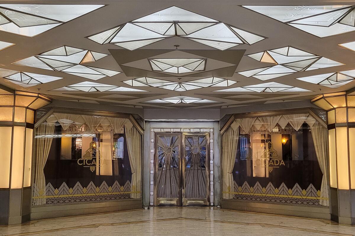 The Art Deco entry to a building has a ceiling of geometric opalescent panels.